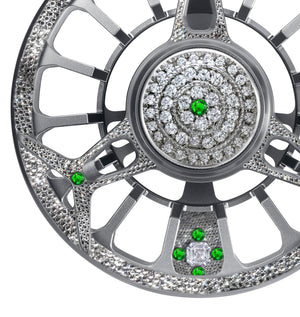 Close-up of the Diamond Drift fly reel featuring silver metalwork encrusted with diamonds and green gemstones.