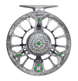 Silver Diamond Drift fly reel embellished with diamonds and green gemstones in a symmetrical, luxury design.