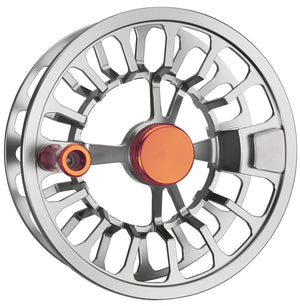 Angled product photo of the Cheeky Spray 350 Burn-Steel fly reel in silver and orange, showing the ergonomic handle and machined frame.