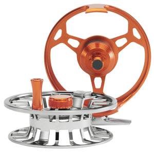 Cheeky Spray 450 Burn-Steel fly reel displayed separated into spool and frame, showing orange and steel color contrast and machined aluminum construction.