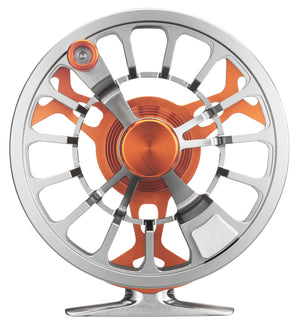 Cheeky Spray 450 Burn-Steel fly reel spool shown from the spool side, featuring a gray steel finish with orange accents and detailed porting.