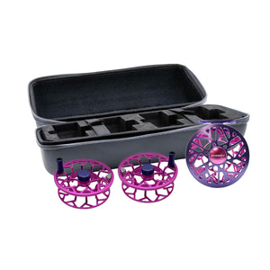 Open hard case containing foam compartments and three purple fly reel spools, one fully assembled reel and two spare spools, shown against a white background.