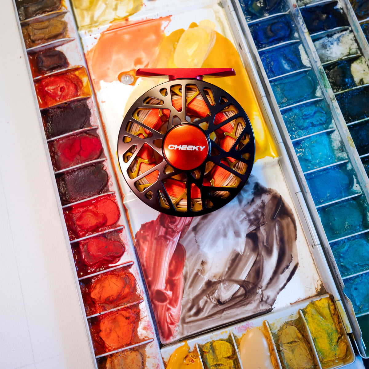 trutta burst 350 reel on a pain pallet showcasing the colors used to design the reel